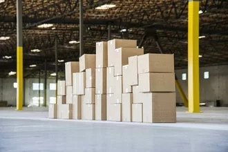 Group of cardboard boxes in a brand new large warehouse space.